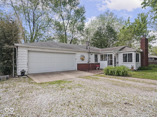 4305 Clinton St, Lawrence, IN 46226 - ranch-style home featuring driveway, a garage, and a chimney