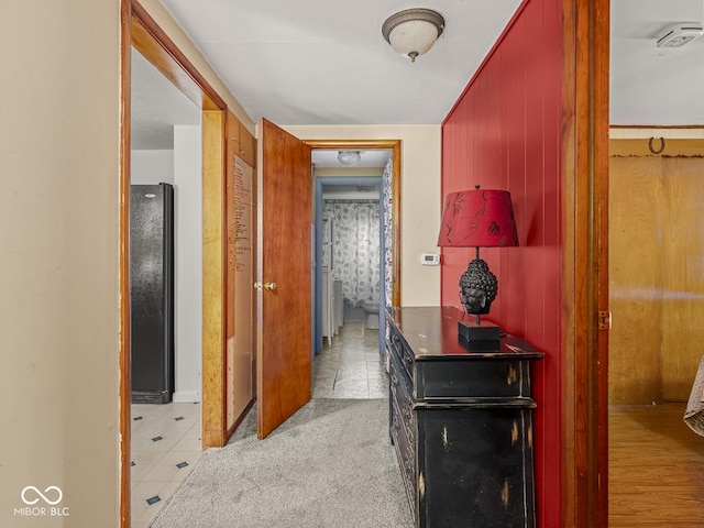 4305 Clinton St, Lawrence, IN 46226 - hall featuring light tile patterned floors and wood walls