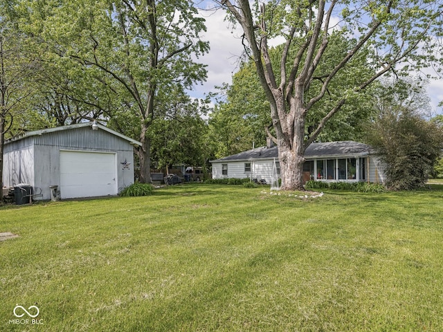 4305 Clinton St, Lawrence, IN 46226 - view of grassy yard with a detached garage and an outdoor structure