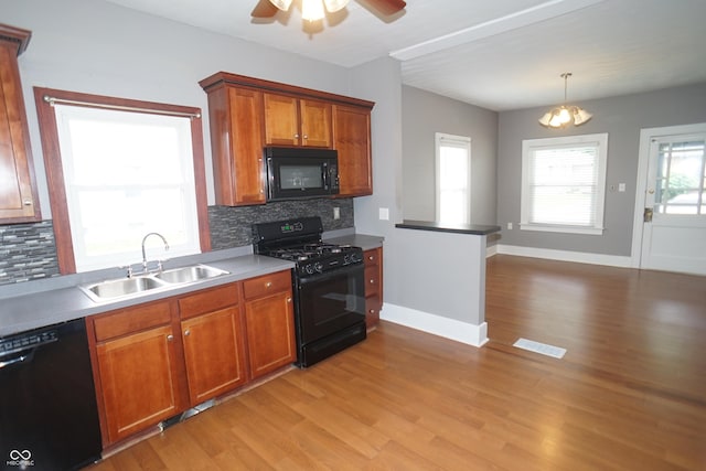 524 Hoene Ave, Batesville, IN 47006 - kitchen with black appliances, a sink, brown cabinets, tasteful backsplash, and light wood-style flooring