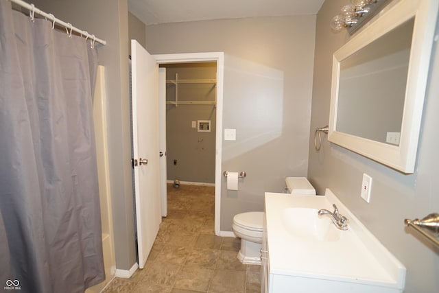 524 Hoene Ave, Batesville, IN 47006 - bathroom featuring vanity, toilet, baseboards, and a shower with shower curtain