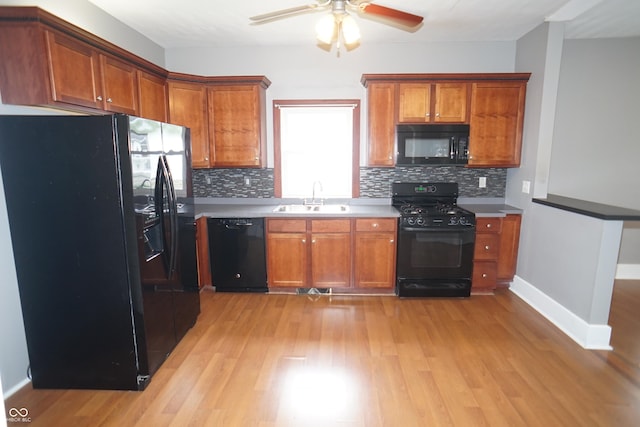 524 Hoene Ave, Batesville, IN 47006 - kitchen with black appliances, a sink, brown cabinets, and light wood-type flooring