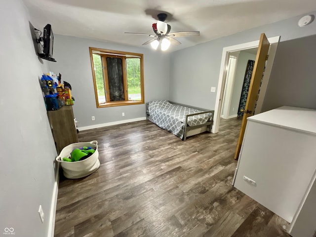 6593 N 800 W, Elwood, IN 46036 - bedroom with dark wood finished floors, baseboards, and ceiling fan