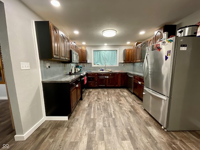 6593 N 800 W, Elwood, IN 46036 - kitchen with stainless steel appliances, backsplash, wood finished floors, a sink, and recessed lighting