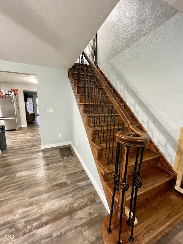 6593 N 800 W, Elwood, IN 46036 - staircase featuring baseboards, a textured ceiling, and wood finished floors