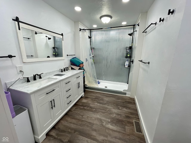 6593 N 800 W, Elwood, IN 46036 - full bath featuring a shower stall, wood finished floors, double vanity, and recessed lighting