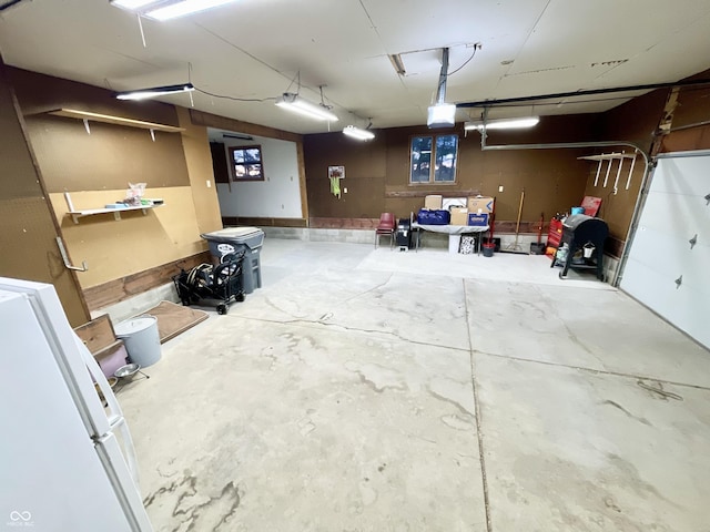 6593 N 800 W, Elwood, IN 46036 - garage with a garage door opener and freestanding refrigerator