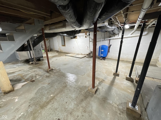 6593 N 800 W, Elwood, IN 46036 - unfinished basement featuring a water pressure tank, electric panel, and stairway