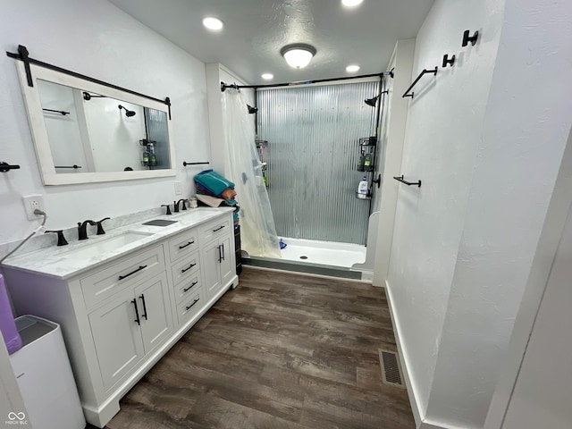 6593 N 800 W, Elwood, IN 46036 - full bathroom featuring a stall shower, double vanity, wood finished floors, and recessed lighting