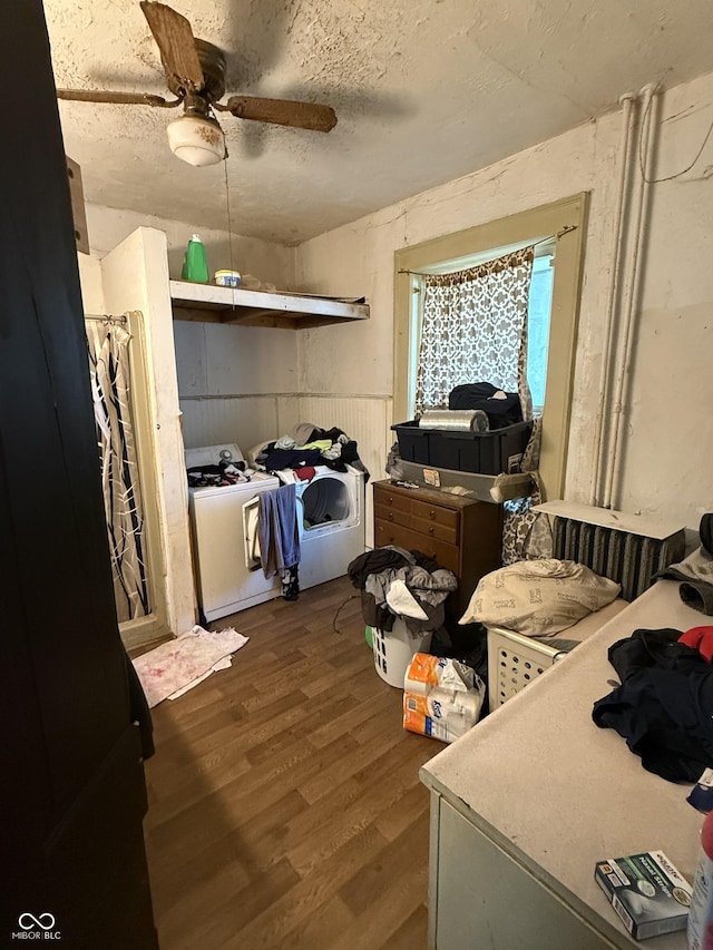 2310 Noble St, Anderson, IN 46016 - bedroom with washing machine and clothes dryer, wood finished floors, ceiling fan, a textured ceiling, and a wainscoted wall