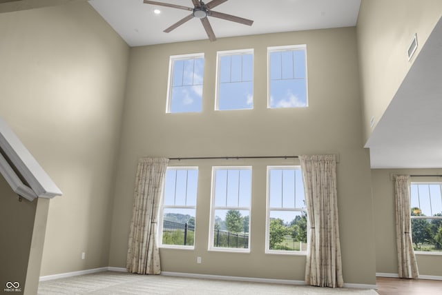 9018 E Gayle Dr, Morgantown, IN 46160 - unfurnished living room featuring a ceiling fan, a high ceiling, and recessed lighting