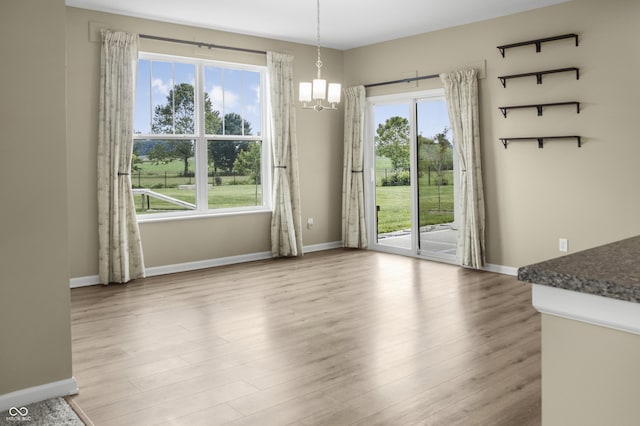 9018 E Gayle Dr, Morgantown, IN 46160 - unfurnished dining area with a chandelier, healthy amount of natural light, and wood finished floors