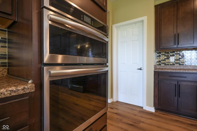 9018 E Gayle Dr, Morgantown, IN 46160 - kitchen with double oven, dark brown cabinets, and decorative backsplash