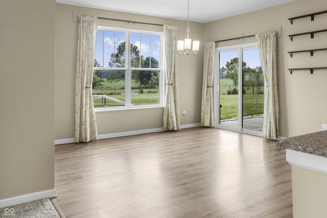 9018 E Gayle Dr, Morgantown, IN 46160 - unfurnished dining area with a chandelier and wood finished floors