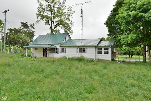 10577 Dalton Rd, Hagerstown, IN 47346 - back of house with metal roof, a chimney, and a porch