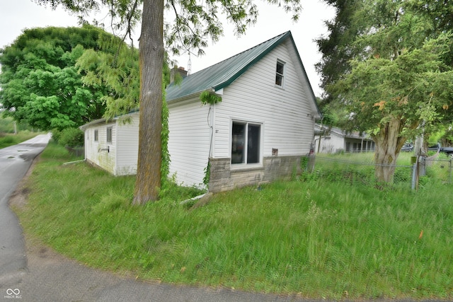 10577 Dalton Rd, Hagerstown, IN 47346 - view of side of home featuring metal roof and stone siding