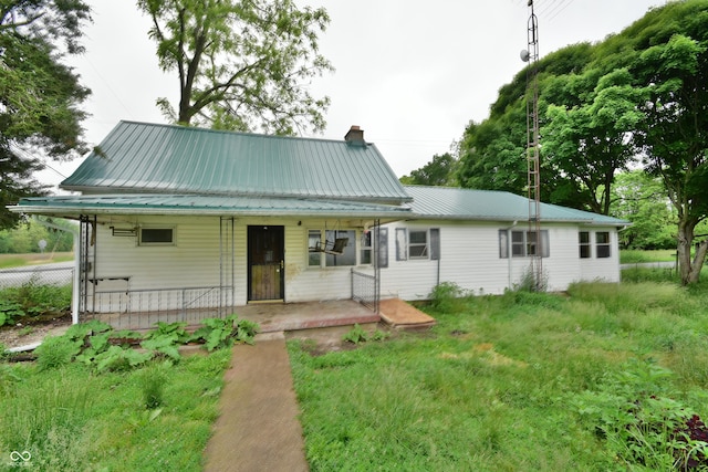 10577 Dalton Rd, Hagerstown, IN 47346 - rear view of property with a chimney, covered porch, and metal roof