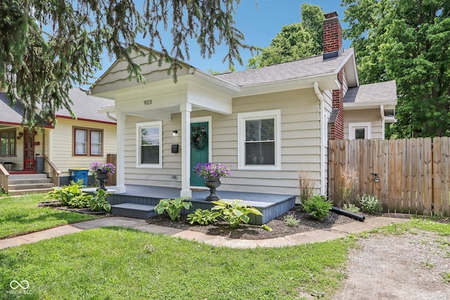 923 42nd St, Indianapolis, IN 46205 - view of front of property featuring a chimney, a shingled roof, and covered porch