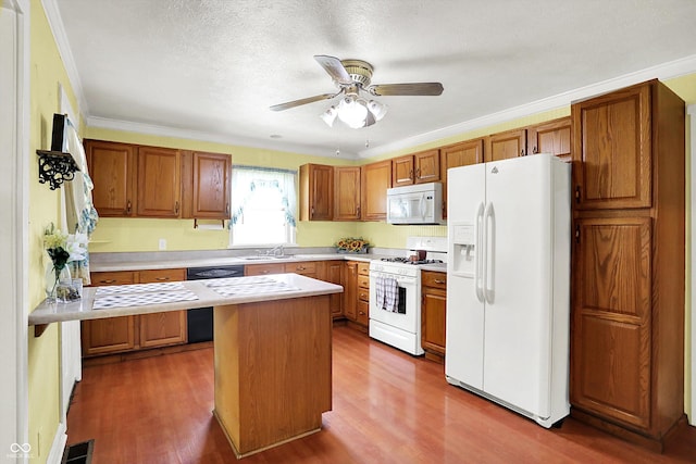 101 Heiny Rd, Indianapolis, IN 46217 - kitchen with white appliances, dark wood-style floors, light countertops, brown cabinetry, and crown molding