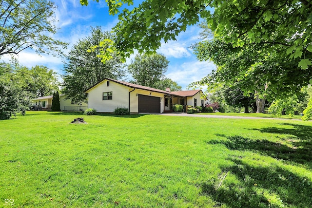 101 Heiny Rd, Indianapolis, IN 46217 - view of front of home featuring an attached garage, a front yard, driveway, and a chimney