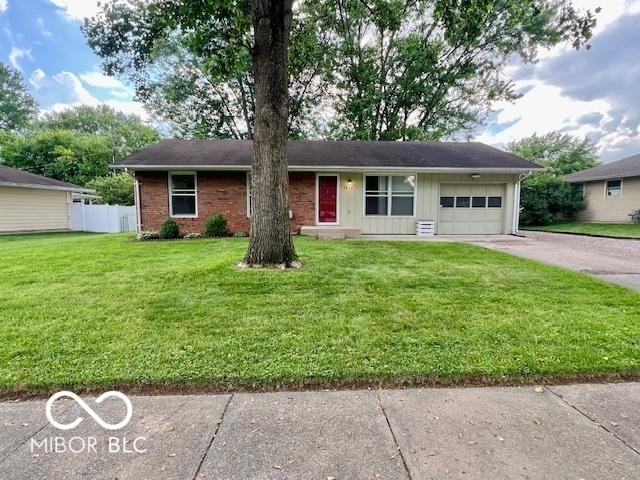 1834 Chandler Ln, Columbus, IN 47203 - ranch-style house featuring a garage, concrete driveway, board and batten siding, and brick siding
