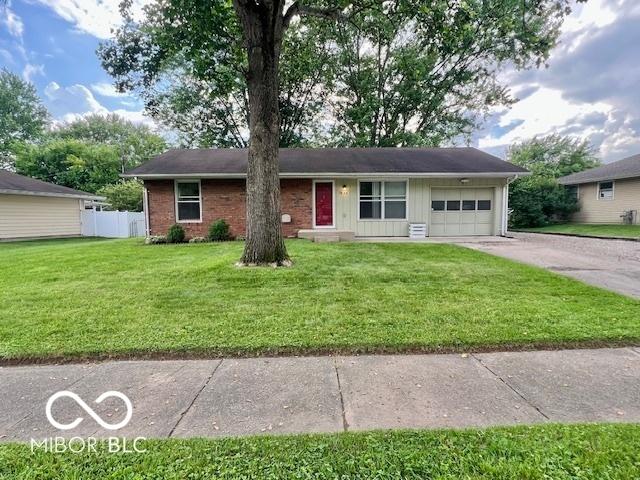 1834 Chandler Ln, Columbus, IN 47203 - ranch-style home with a garage, concrete driveway, board and batten siding, and brick siding