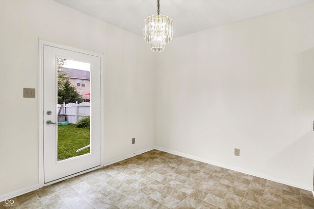 630 Harmony Way, Greenwood, IN 46143 - spare room featuring a chandelier and baseboards
