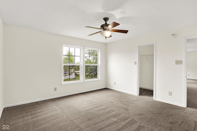 630 Harmony Way, Greenwood, IN 46143 - unfurnished bedroom featuring carpet flooring, a spacious closet, baseboards, a closet, and ceiling fan