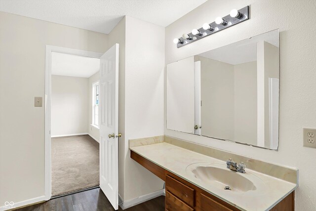 630 Harmony Way, Greenwood, IN 46143 - bathroom featuring vanity, wood finished floors, and baseboards