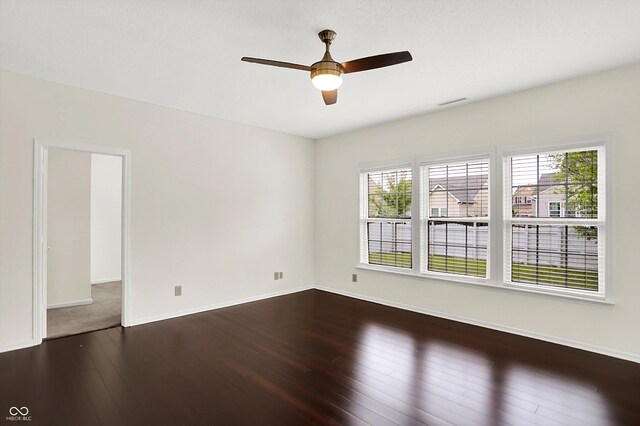 630 Harmony Way, Greenwood, IN 46143 - unfurnished room with dark wood-style floors, ceiling fan, and baseboards
