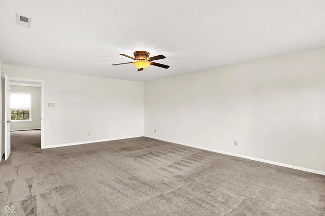 630 Harmony Way, Greenwood, IN 46143 - spare room featuring ceiling fan, carpet floors, and baseboards