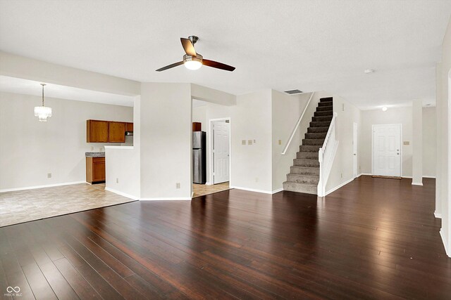 630 Harmony Way, Greenwood, IN 46143 - unfurnished living room featuring a ceiling fan, stairway, hardwood / wood-style flooring, and baseboards
