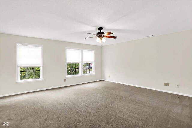 630 Harmony Way, Greenwood, IN 46143 - unfurnished room featuring dark colored carpet, healthy amount of natural light, ceiling fan, and baseboards