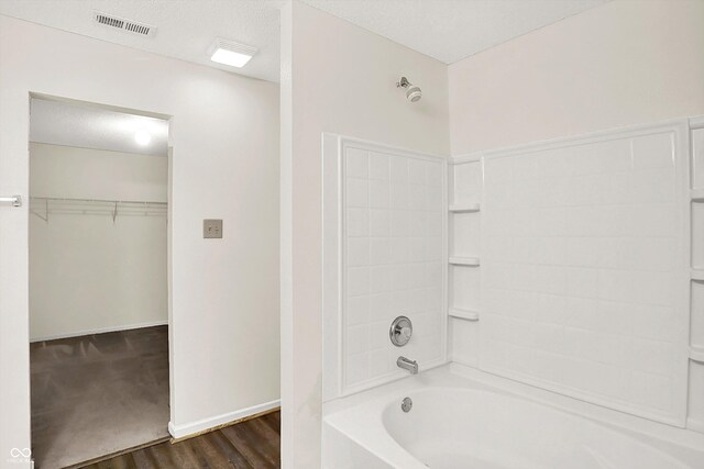 630 Harmony Way, Greenwood, IN 46143 - bathroom with wood finished floors, shower / bath combination, a spacious closet, and baseboards