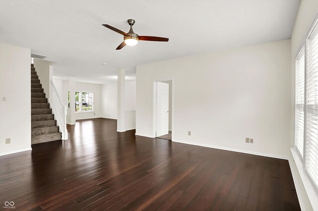 630 Harmony Way, Greenwood, IN 46143 - unfurnished living room featuring dark wood finished floors, ceiling fan, stairs, and baseboards