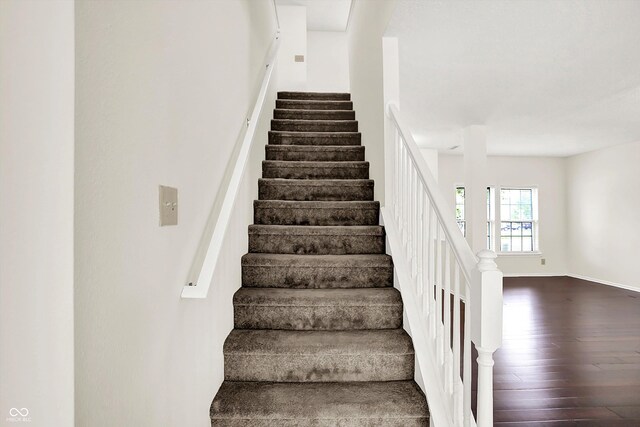 630 Harmony Way, Greenwood, IN 46143 - stairs featuring wood finished floors and baseboards
