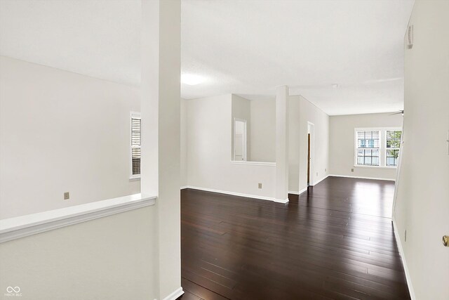 630 Harmony Way, Greenwood, IN 46143 - empty room featuring dark wood-style floors, baseboards, and a ceiling fan