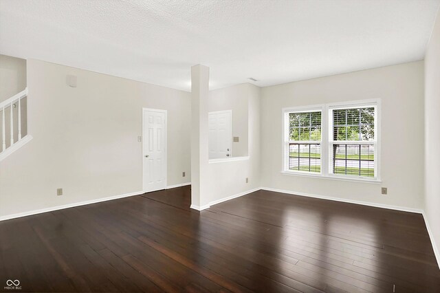 630 Harmony Way, Greenwood, IN 46143 - spare room featuring dark wood finished floors, stairs, and baseboards