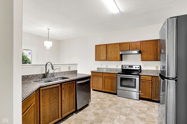 630 Harmony Way, Greenwood, IN 46143 - kitchen featuring stainless steel appliances, a sink, brown cabinetry, under cabinet range hood, and a textured ceiling