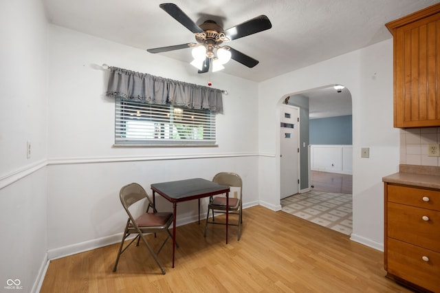 5092 S 50 W, Anderson, IN 46013 - dining room with arched walkways, ceiling fan, light wood-style floors, and baseboards
