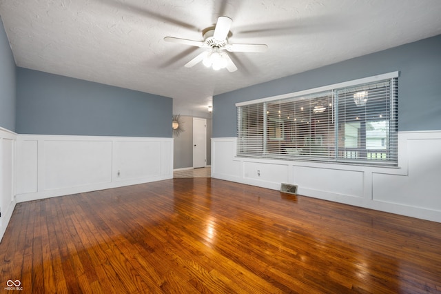 5092 S 50 W, Anderson, IN 46013 - empty room with a wainscoted wall, ceiling fan, a decorative wall, wood finished floors, and a textured ceiling