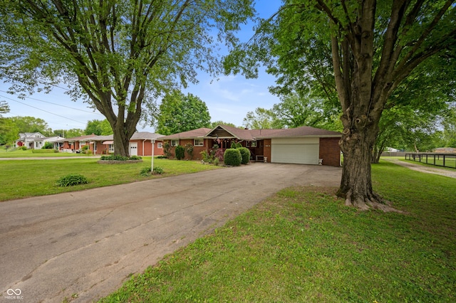 5092 S 50 W, Anderson, IN 46013 - ranch-style home with driveway, a garage, a front lawn, and brick siding