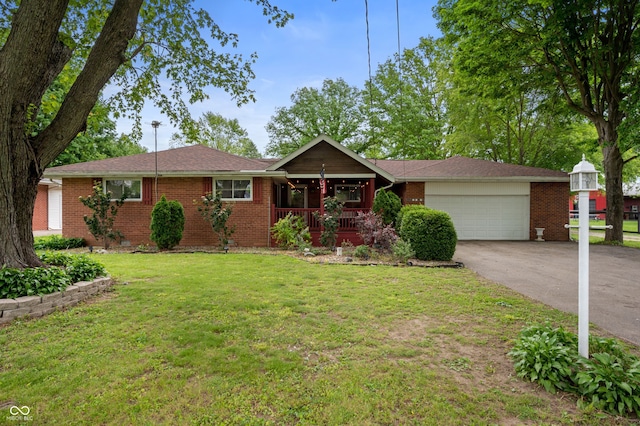 5092 S 50 W, Anderson, IN 46013 - ranch-style house featuring an attached garage, covered porch, concrete driveway, a front lawn, and brick siding