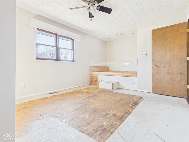 619 Belzer Dr, Anderson, IN 46011 - empty room with ceiling fan, a textured ceiling, and baseboards