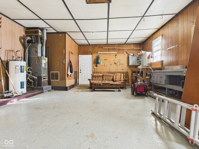 619 Belzer Dr, Anderson, IN 46011 - garage featuring electric water heater, wooden walls, and heating unit