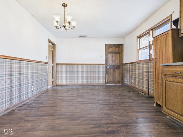 619 Belzer Dr, Anderson, IN 46011 - unfurnished dining area featuring wainscoting, wallpapered walls, a chandelier, wood finished floors, and baseboards