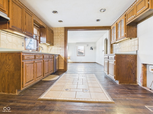 619 Belzer Dr, Anderson, IN 46011 - kitchen featuring dark wood-type flooring, brown cabinetry, tasteful backsplash, light countertops, and recessed lighting