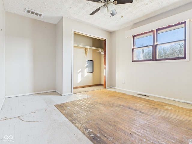 619 Belzer Dr, Anderson, IN 46011 - unfurnished bedroom featuring baseboards, a closet, a textured ceiling, and a ceiling fan