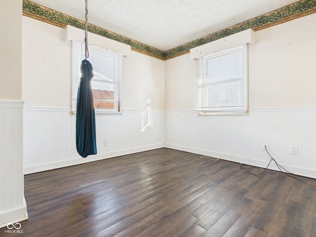 619 Belzer Dr, Anderson, IN 46011 - unfurnished room with a wainscoted wall and wood finished floors