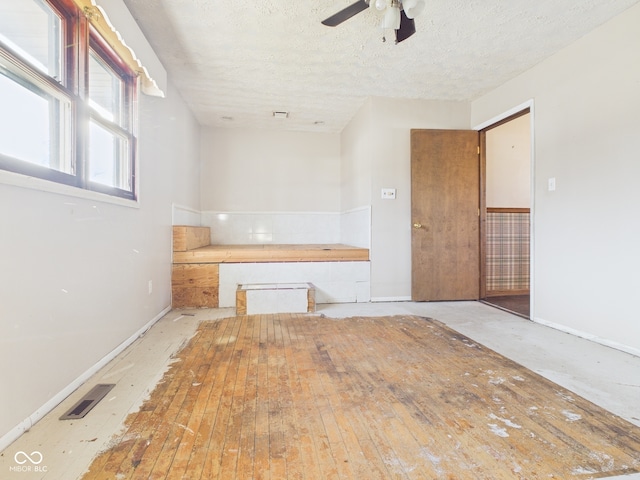 619 Belzer Dr, Anderson, IN 46011 - empty room featuring a ceiling fan, baseboards, and a textured ceiling